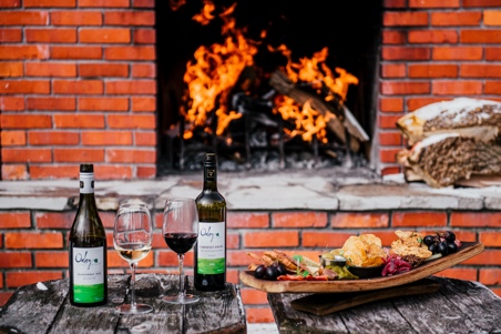 oxley wine with charcuterie outside at fire